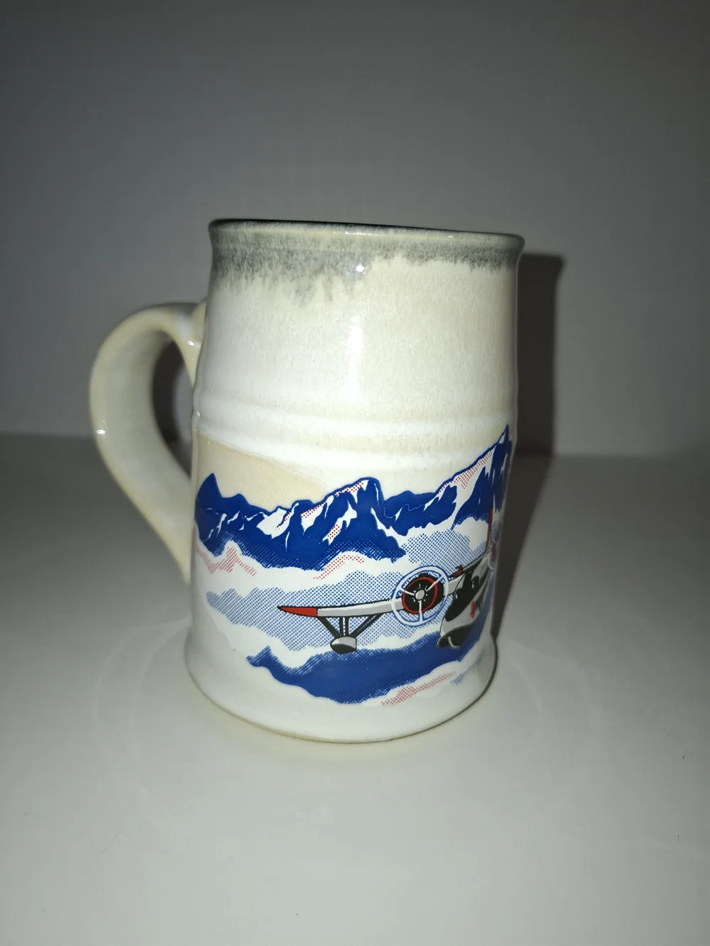 Cream Ceramic Airplane Mug with Blue Mountain Scene